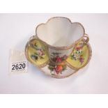A Meissen two handled cup and saucer painted with courting couples