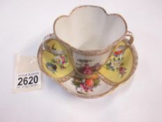 A Meissen two handled cup and saucer painted with courting couples