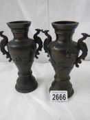 A pair of late Victorian bronze vases in good condition, 6.6".