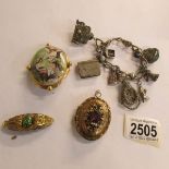 A Yellow metal pendant, 2 brooches and a charm bracelet.
