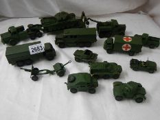 14 Dinky military vehicles including tank transporter, field gun set, ambulance etc.