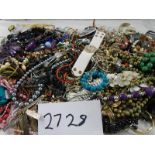 A large quantity of unsorted costume jewellery.