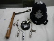 A collection of 20th century police memorabilia including hand cuffs, trucheon,helmet etc.