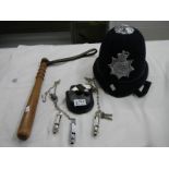 A collection of 20th century police memorabilia including hand cuffs, trucheon,helmet etc.