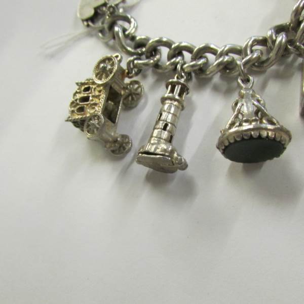 A very good quality 1970's charm bracelet with 11 charms in total including 4 opening, - Image 2 of 4