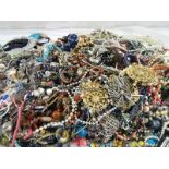 A large quantity of unsorted costume jewellery.