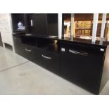 A low black finished sideboard with cupboards and drawers