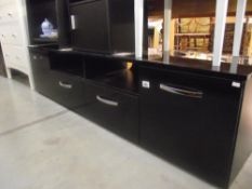 A low black finished sideboard with cupboards and drawers