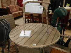 A wicker conservatory table and 4 chairs.