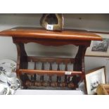 A mahogany magazine rack with table top