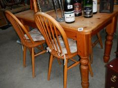 An old pine kitchen table and 2 pairs of chairs.