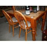 An old pine kitchen table and 2 pairs of chairs.