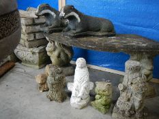 2 concrete badgers and 5 other garden ornaments.