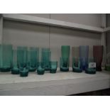 A quantity of vintage coloured drinking glasses