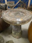 A freestanding bird bath.