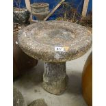 A freestanding bird bath.