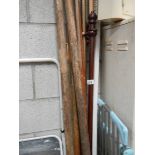 A quantity of curtain poles and boat oars.