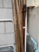 A quantity of curtain poles and boat oars.