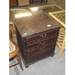 An embossed leather covered small 4 drawer chest of drawers