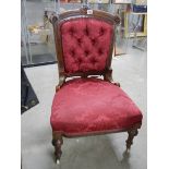 A good Edwardian bedroom chair deep buttoned in burgundy.
