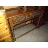 A medium oak side/hall table with 2 carved drawers