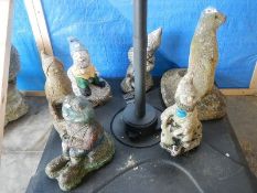 A quantity of garden gnomes, a frog and an otter.