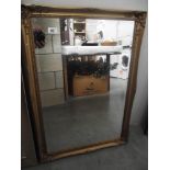 A gilded framed mirror