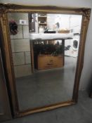 A gilded framed mirror