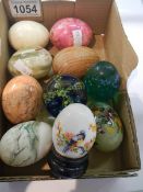 A mixed lot of ornamental and stone eggs.
