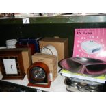 2 shelves of kitchen ware and 4 good boxed unused battery clocks.