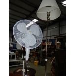 An electric standard lamp and a freestanding fan.