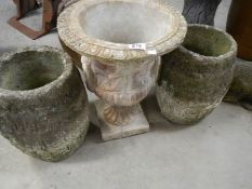 A matching pair of crucible garden urns and one other.