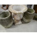 A matching pair of crucible garden urns and one other.