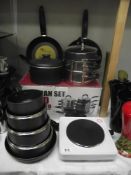 A quantity of new saucepans and a one ring cooking hob