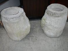 A pair of log shaped garden pots.