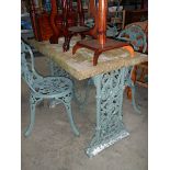 An early 20th century stone topped cast iron garden table and 2 chairs.