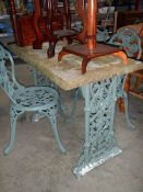 An early 20th century stone topped cast iron garden table and 2 chairs.