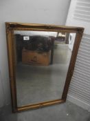 A gilded framed mirror