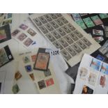A large quantity of loose and sheets of stamps.