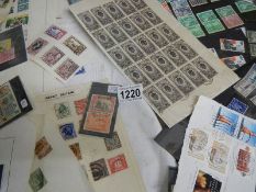 A large quantity of loose and sheets of stamps.