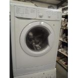 An Indesit washing machine (damage to inspection panel)