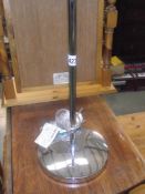 A chromed articulating arm lamp stand