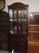 A drakwood stained glazed top display wall unit