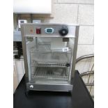 A glass sided commercial counter top food heater cabinet