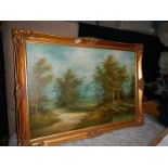 A gilt framed oil on canvas woodland scene.
