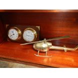 A solid brass helicopter and a ships style clock barometer.
