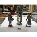 Two metal figures of American Indians and a soldier.