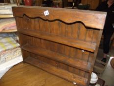 A dark wood stained pine wall mounted set of shelves