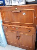 A drop front teak desk.