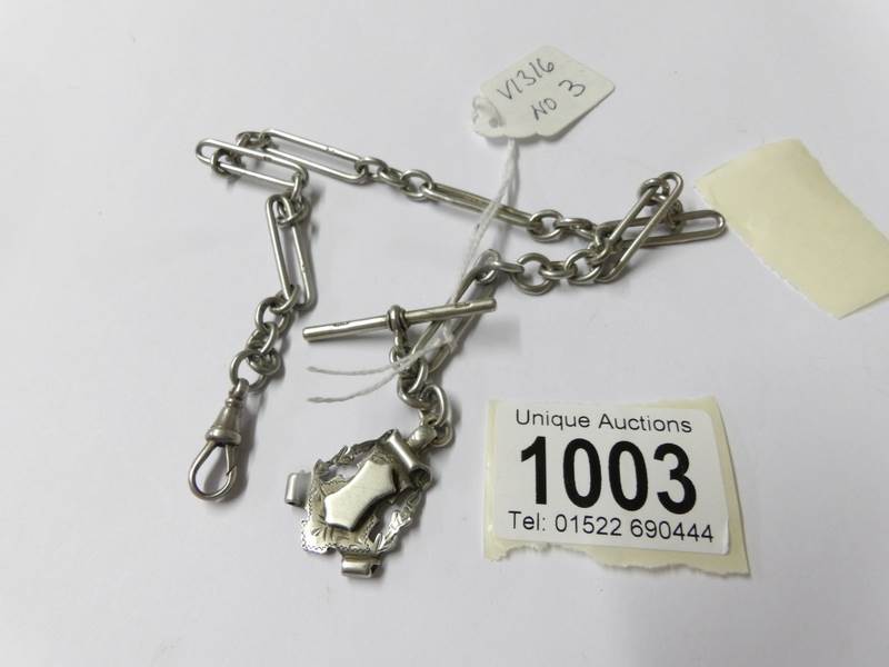 A silver full Albert chain, fancy link, dated Birmingham 1901 with shield shape fob. 33.8 grams.